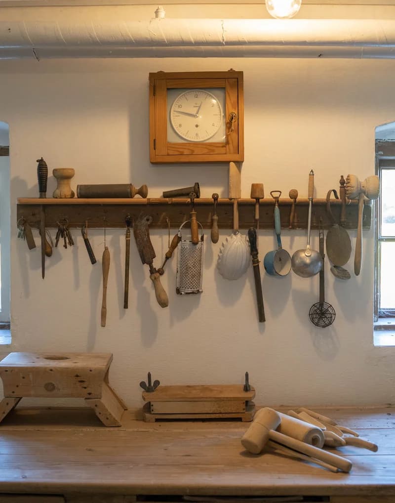 Køkkenredskaber på væggen i det historiske køkken